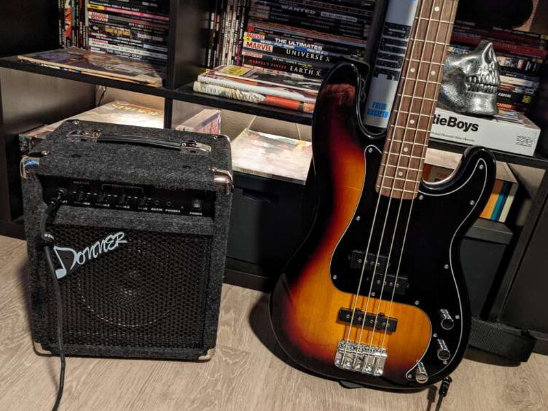 The Donner DBA-1 beside the Squier bass after testing.