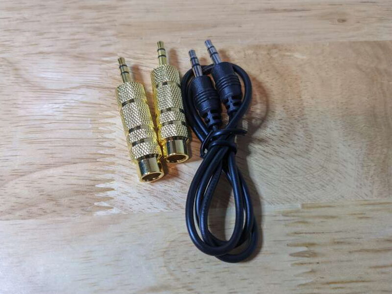 Two 1/4 inch to 1/8 inch adaptors and a 1/8 inch stereo cable are included for auxiliary and headphone setups.