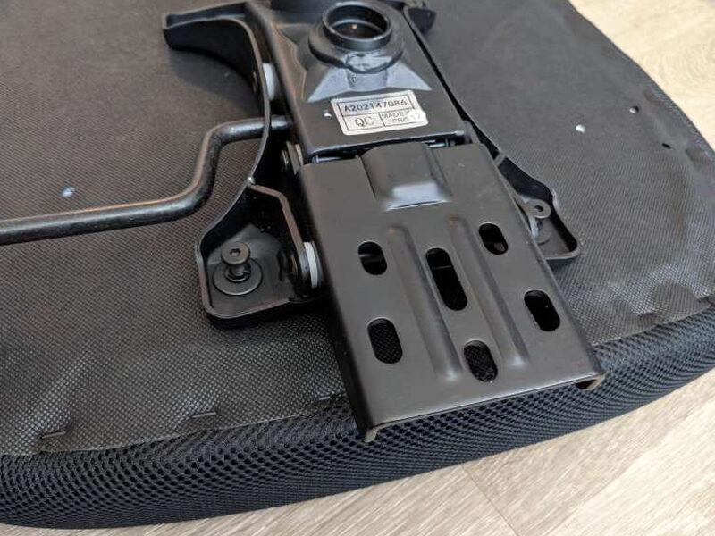 The mechanism’s slotted mounting plate up close.