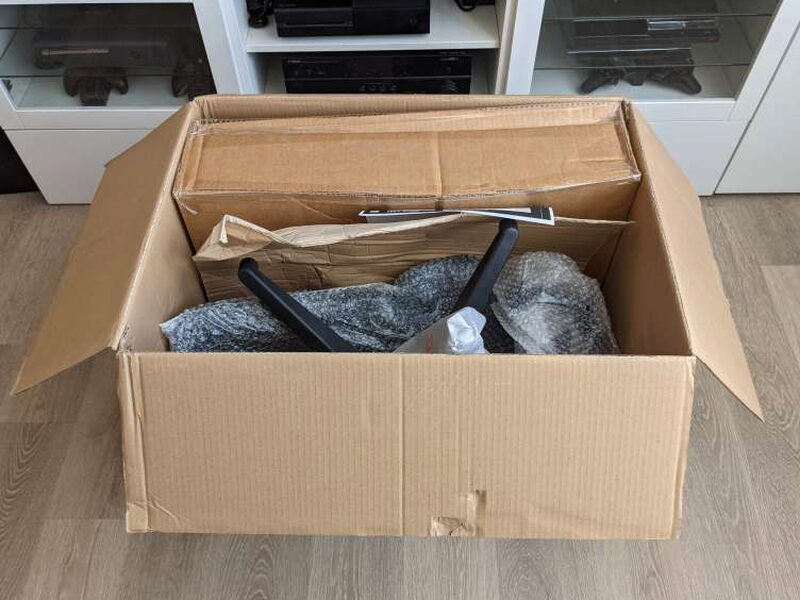 Parts wrapped and cushioned inside the shipping box.
