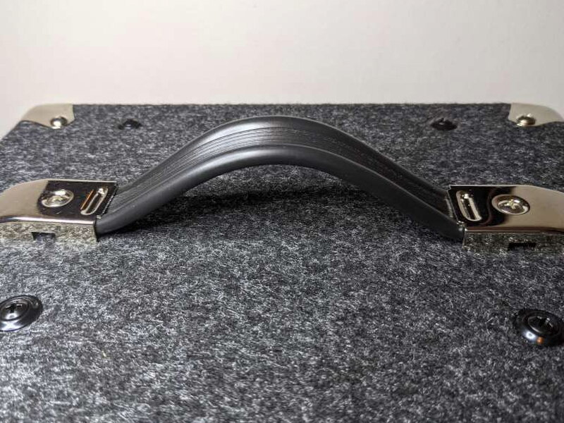 The top handle is secured with metal brackets and feels sturdy.