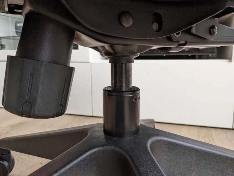 The gas lift’s top collar aligning with the mechanism’s socket.