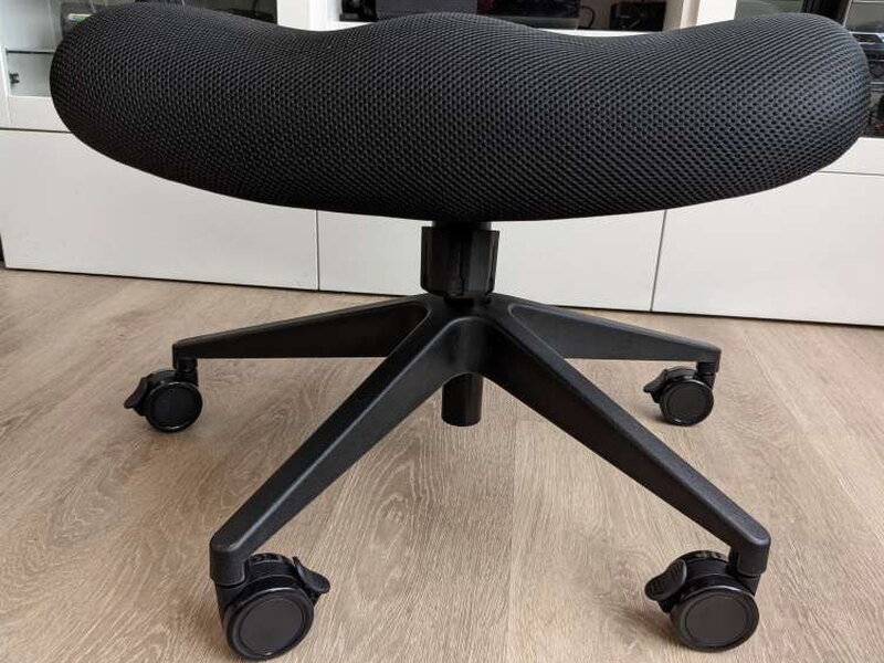 The seat and armrests resting on the base, gas lift not yet connected.