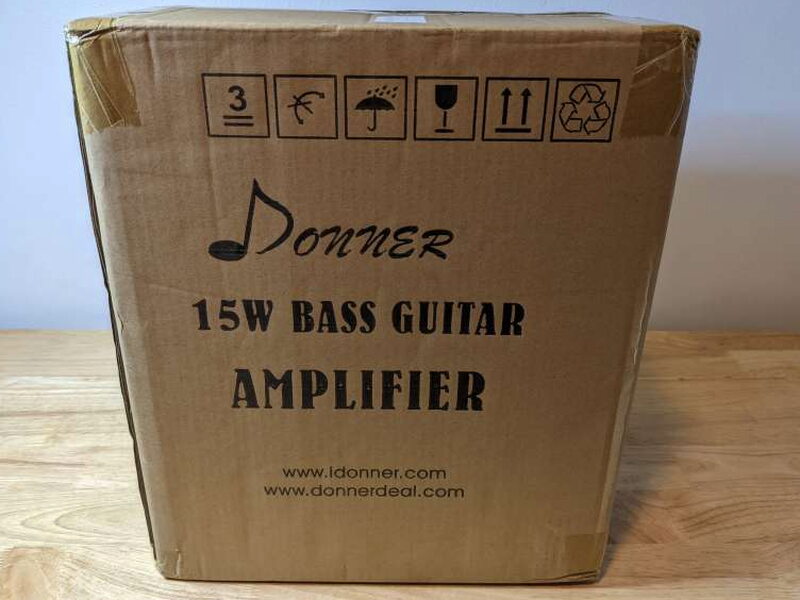 The shipping box identifies the Donner DBA-1 as a 15W bass guitar amplifier.