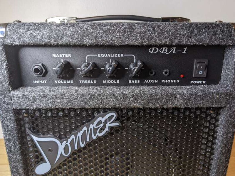 The front control panel has volume, treble, middle, bass, auxiliary, and power controls.