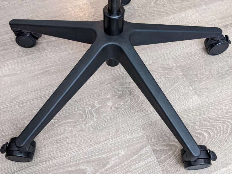 The wide 5-star base, plastic despite the matte black finish.
