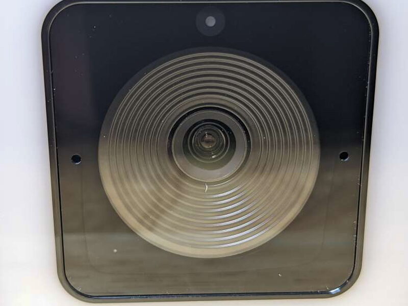 The lens, sensor, microphones, and circular LED pattern are visible through the front panel.