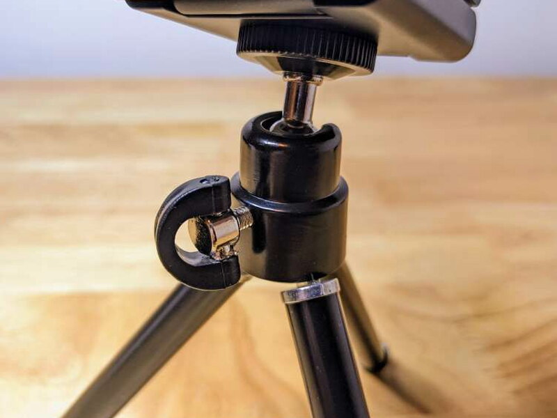 The tripod head and adjustment knob allow angled positioning.