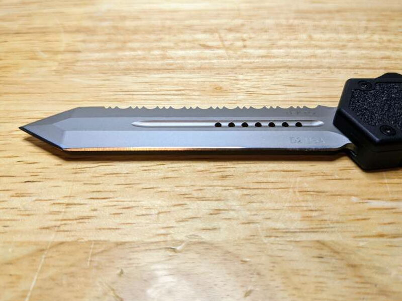 The D2 blade has serrations on one edge and a plain edge on the other.
