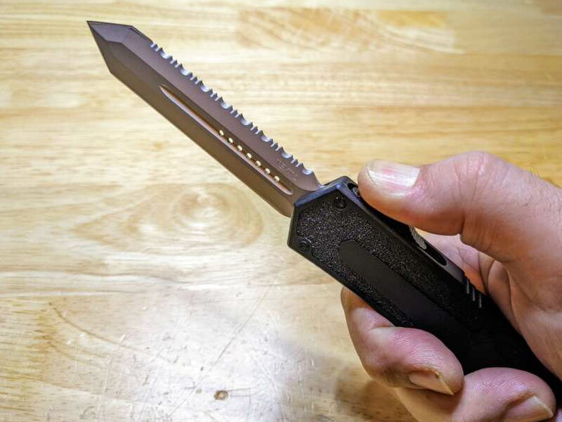 A closer view of the black D2 steel blade and its center groove.