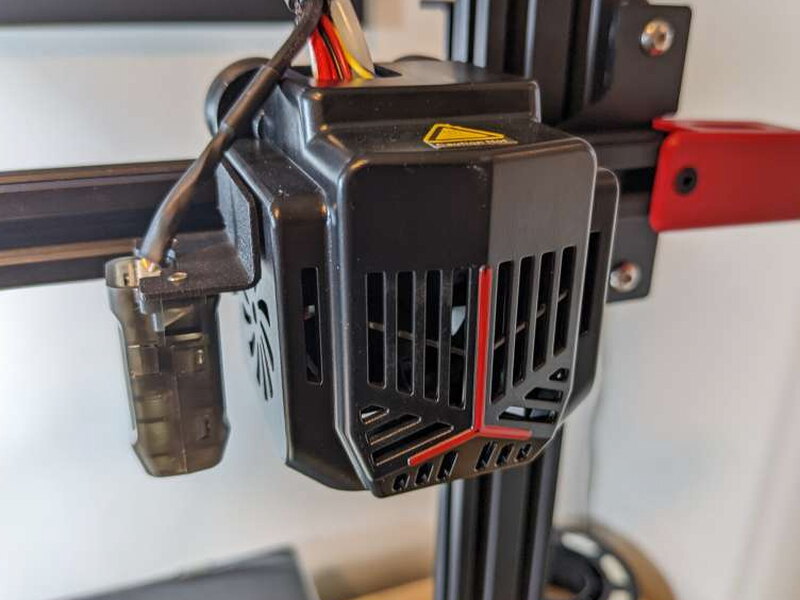 The hotend shroud uses red stripes to match the other control accents.
