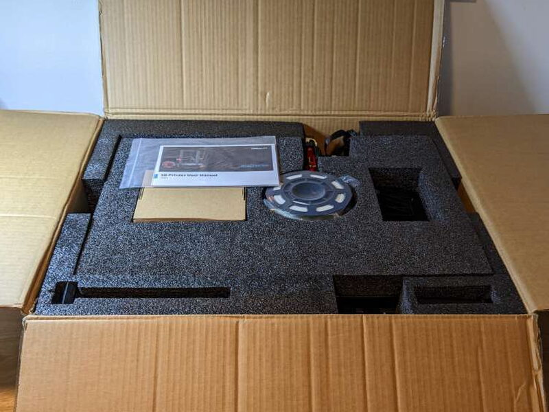 Thick foam inserts protect the printer parts and accessories inside the box.