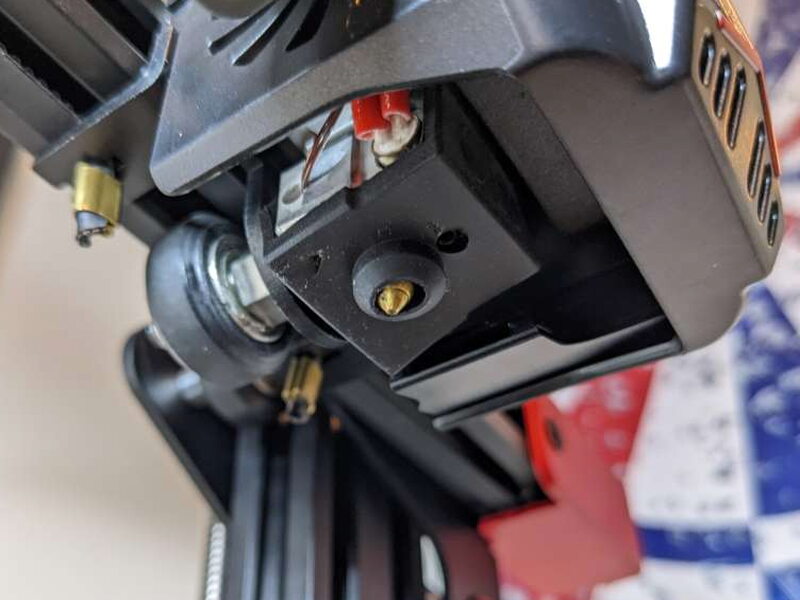Close view of the 0.4mm brass nozzle below the hotend.