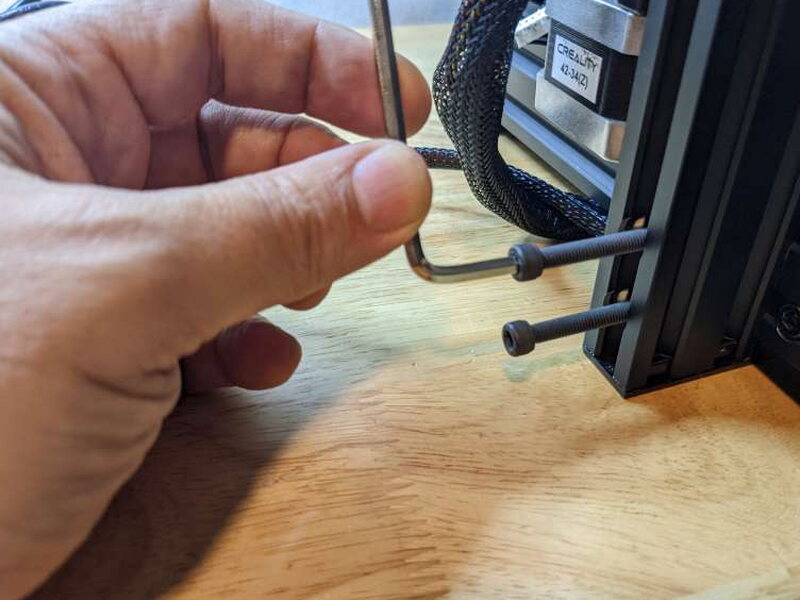 Tightening one of the gantry bolts with the large included Allen wrench.