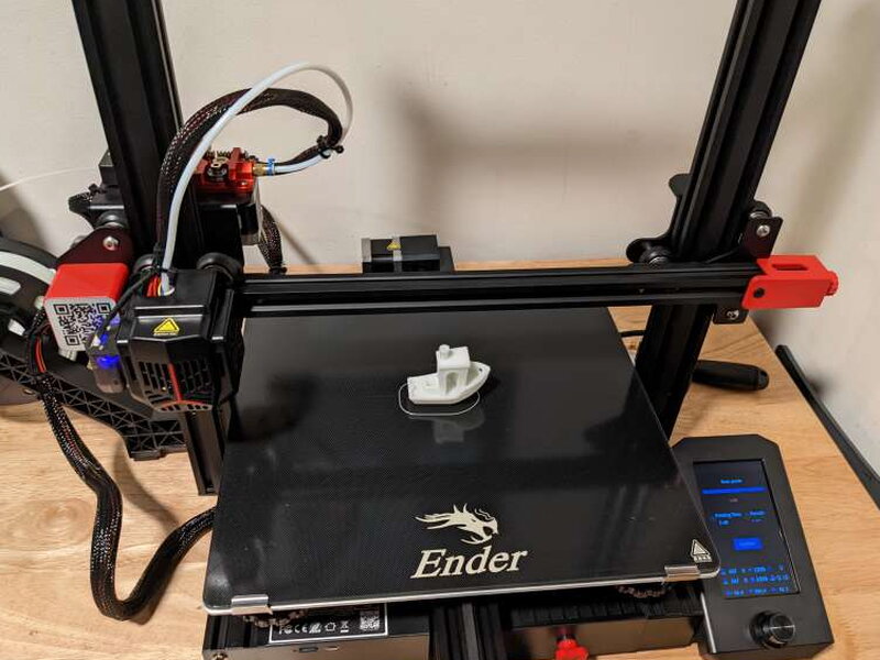 The Ender 3 Max Neo printing Benchy on the glass bed.
