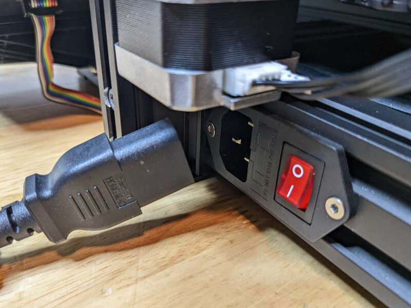 The power cord and power switch after the voltage has been set correctly.