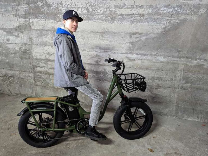 The T1 Pro ready for testing with the rider standing beside it.