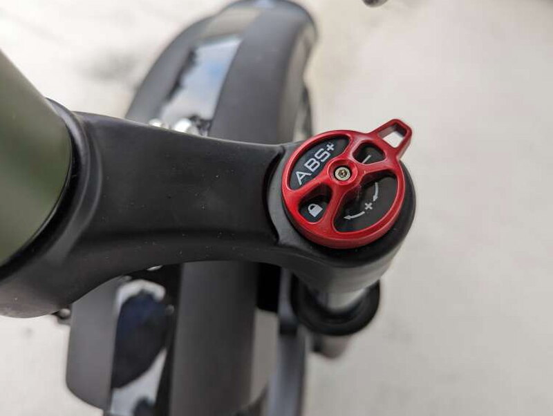 The red fork adjustment dial used to tune the front suspension feel.