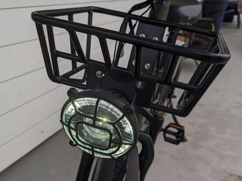 The front cargo basket with the oversized headlight mounted beneath it.
