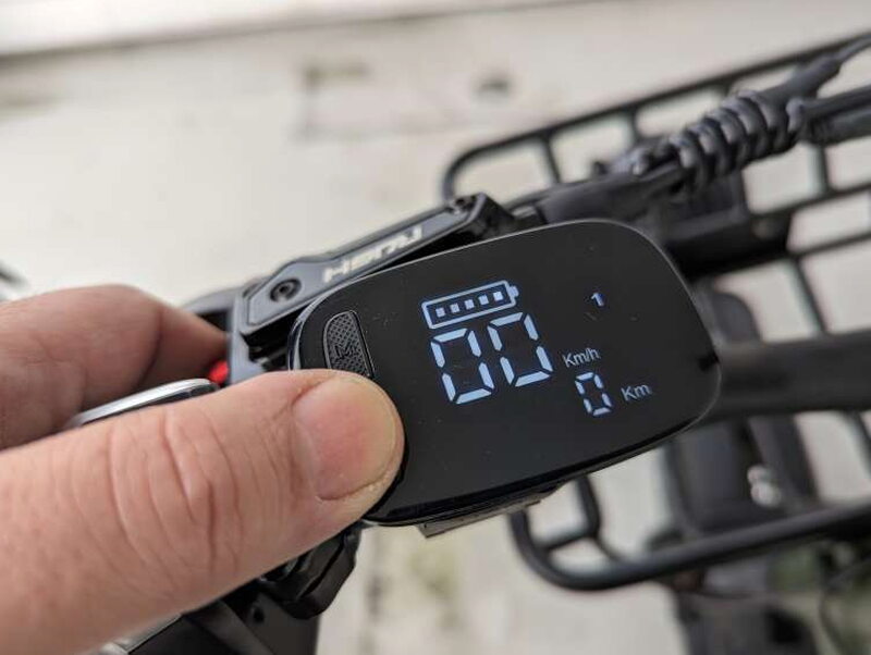 The LED display showing speed, battery level, PAS mode, light status, and range information.