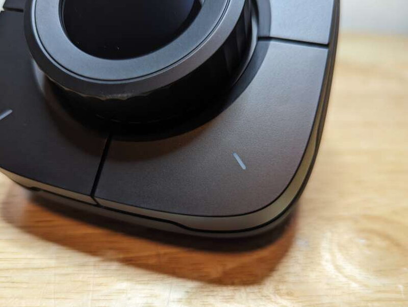 One of the four corner buttons, each with its own small multicolor LED hash mark and the same satisfying click as the dial.