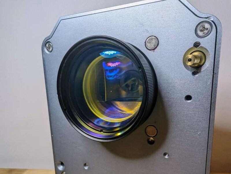 The lens itself, throwing off a little rainbow in the light. My unit shipped with the 110mm x 110mm lens; a 150mm x 150mm option is available for a bigger working area.