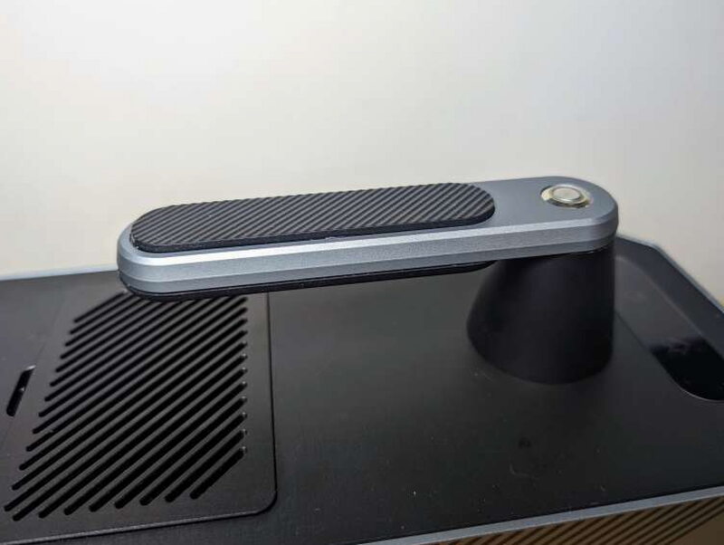 The rubber-gripped handle up top, with the power button built into it.