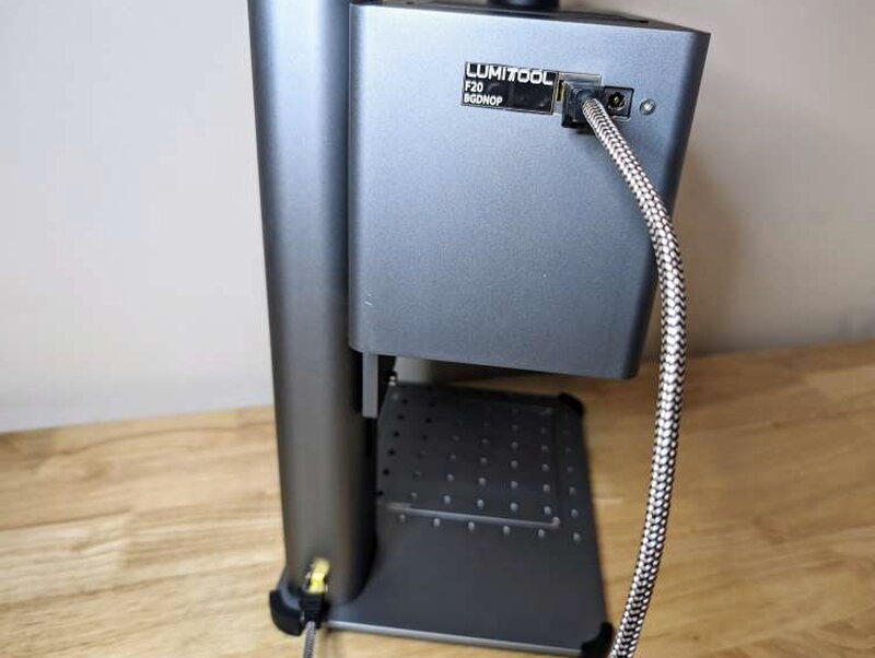 The braided data cable plugged into the back of the head.