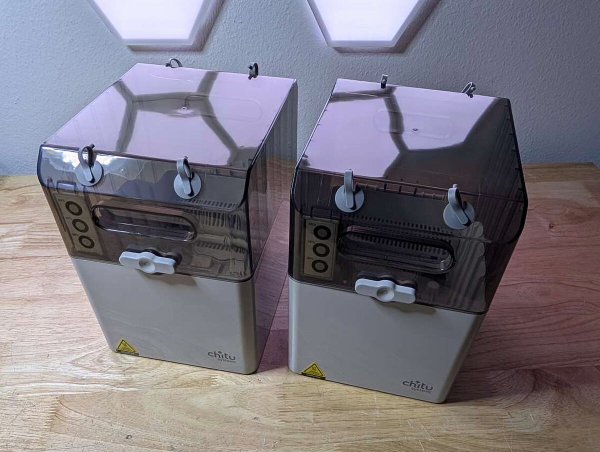 Two FilaPartner E1 filament boxes on the base