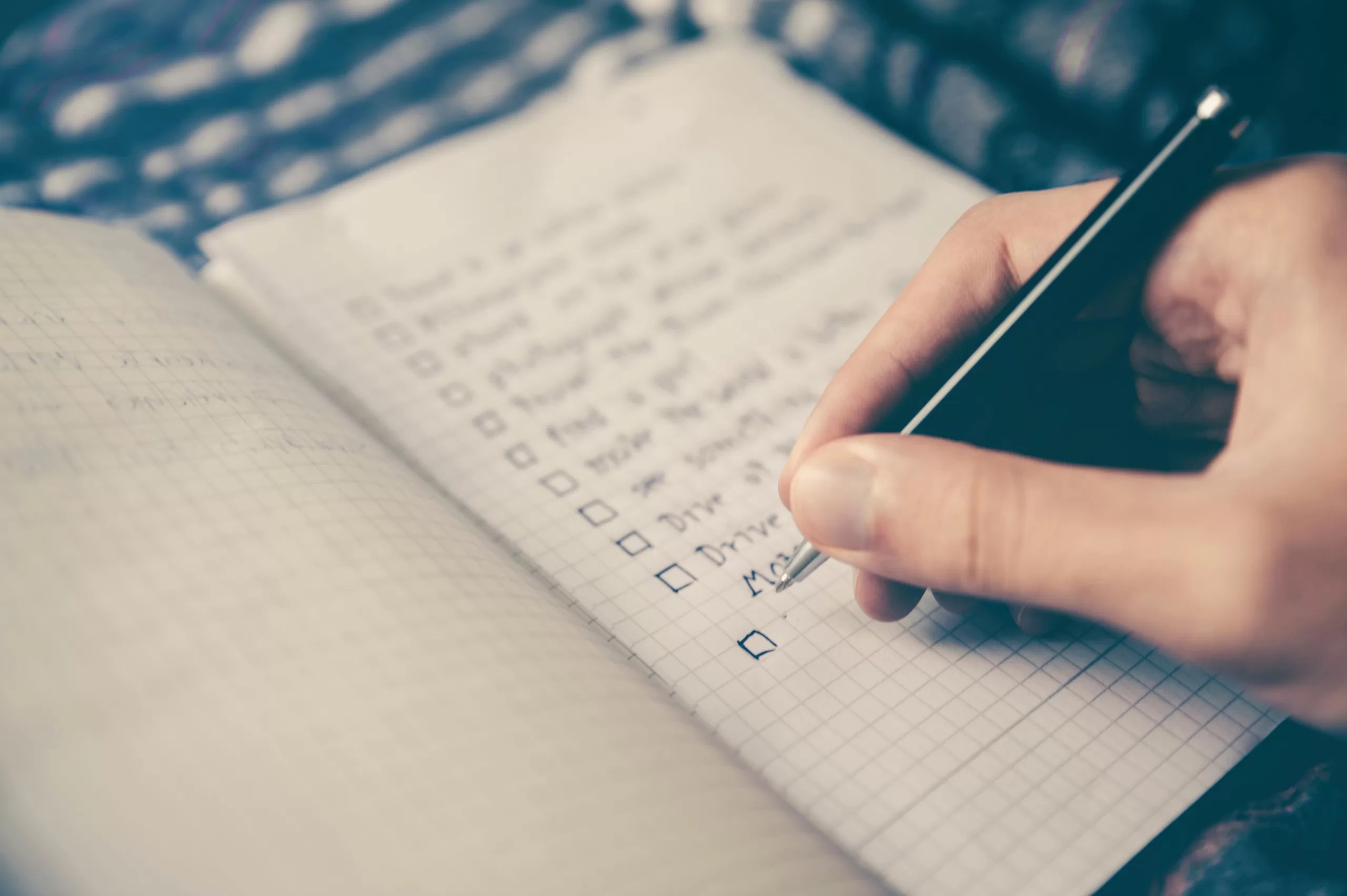 A hand writing in a notebook.