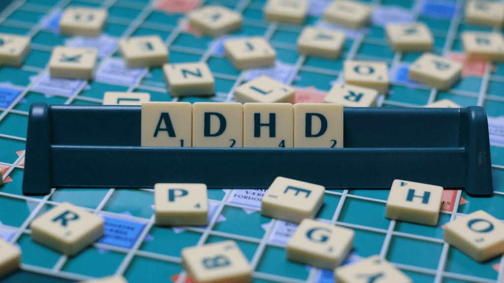 This is a decorative image of scrabble game pieces spelling out ADHD. This accompanies a case study on ADHD.