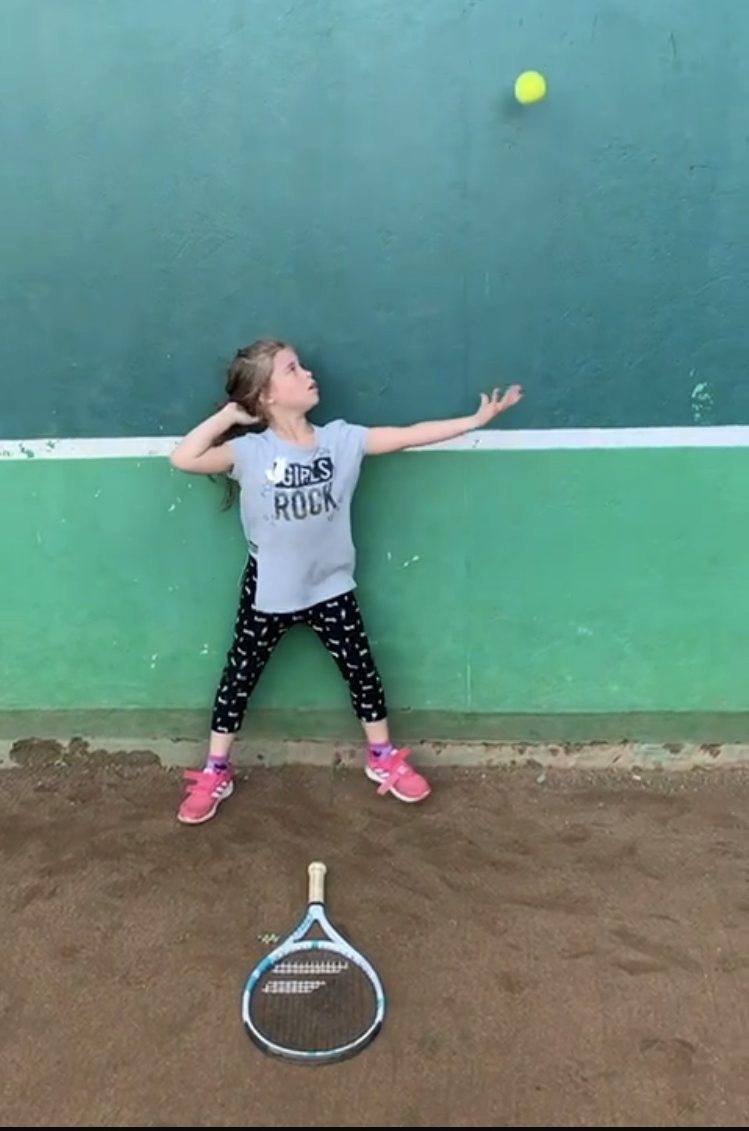 Tennis ball toss by the girl