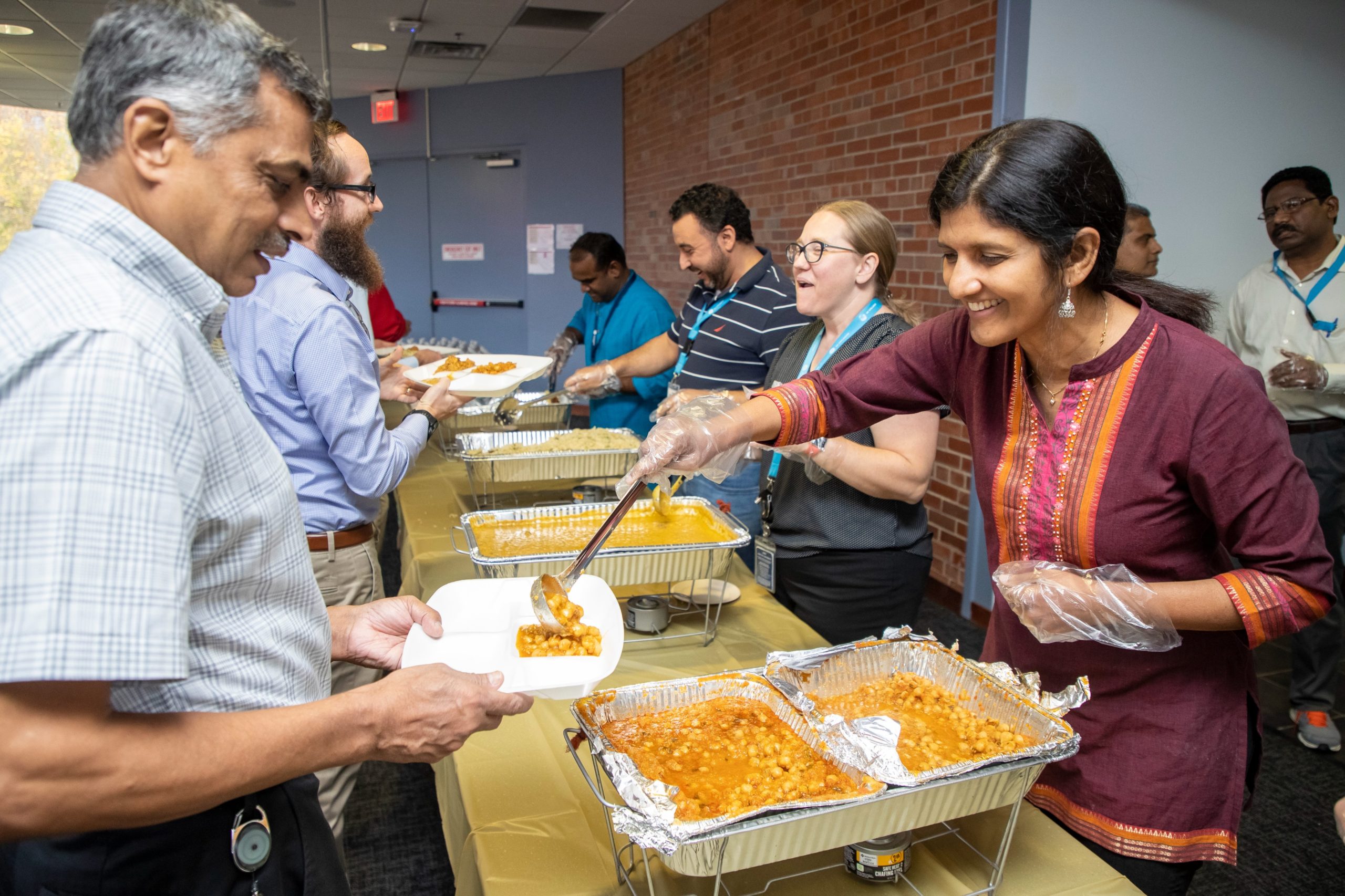 GE Appliances employees are served food by volunteers in a buffet line