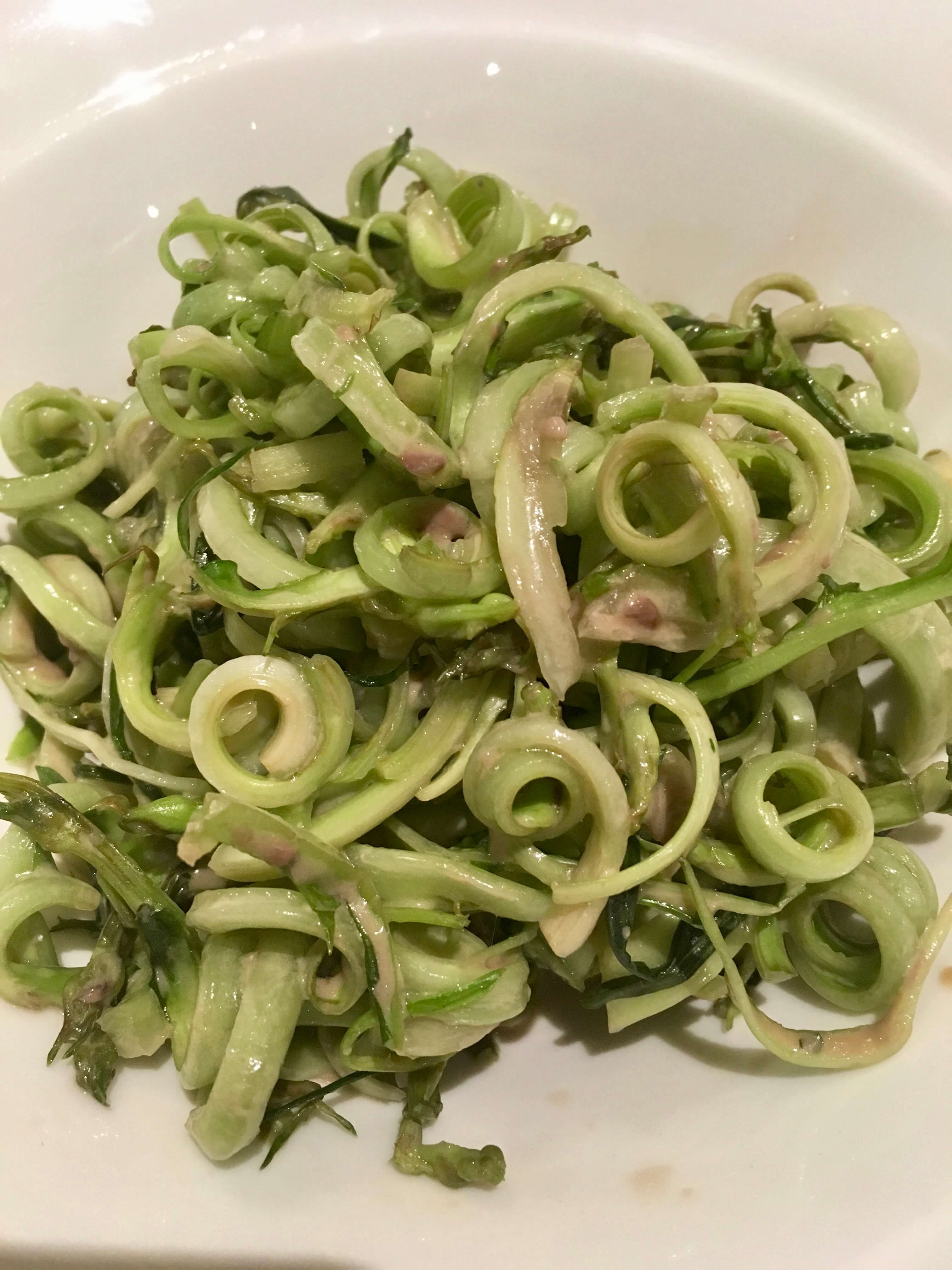 Puntarelle salad in Rome, Italy. Puntarelle are in the chicory family, and in Rome they're dressed with a mixture of olive oil, vinegar, garlic, anchovies, and salt and pepper.