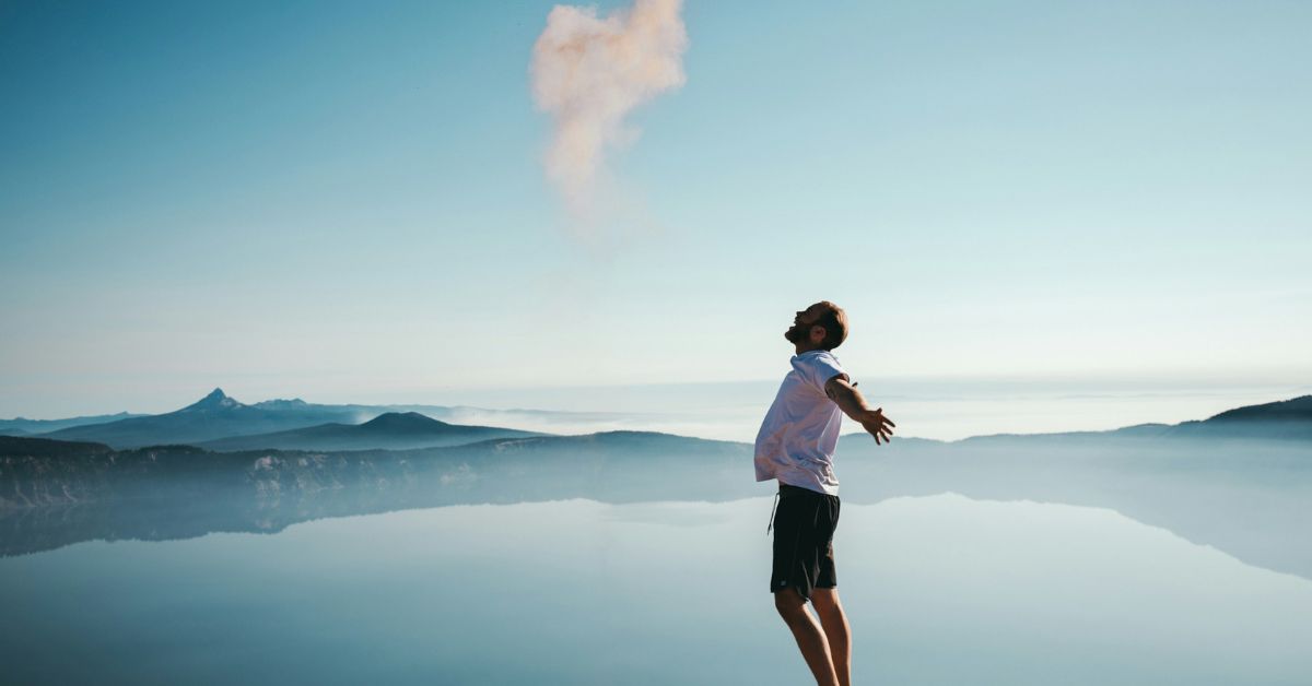 A man looking up to the sky with skyline background