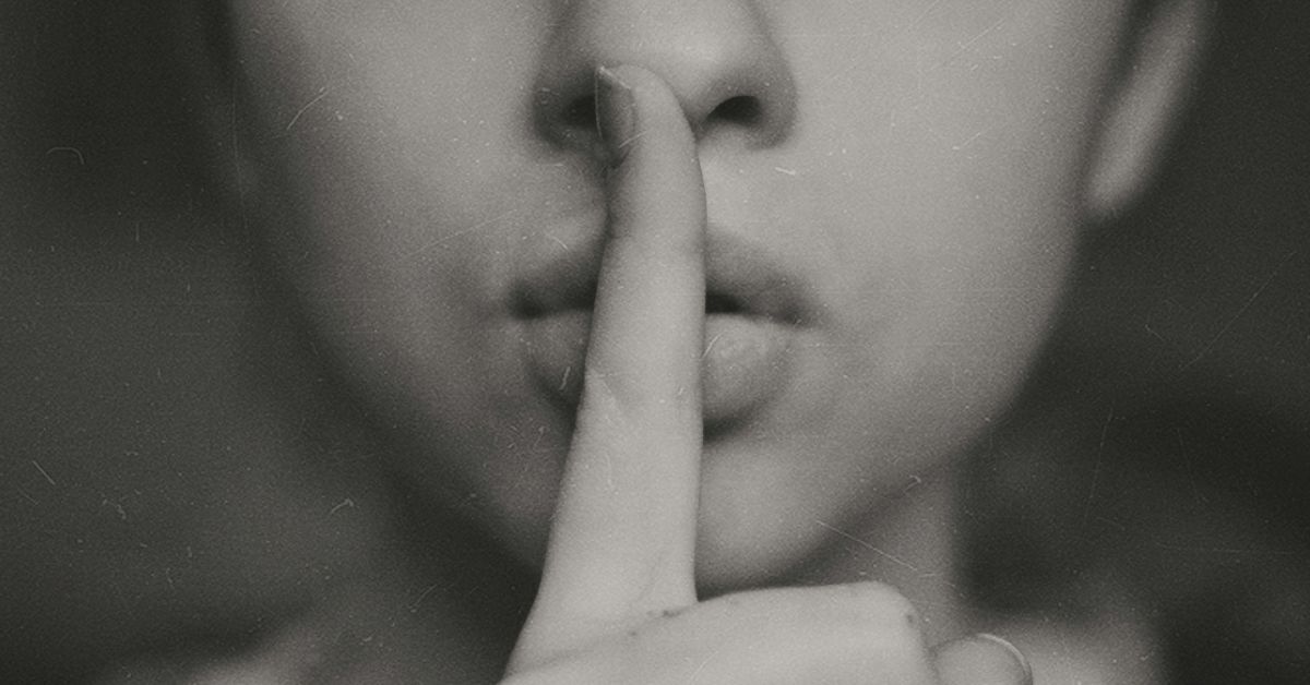 A women with fingers on lips
