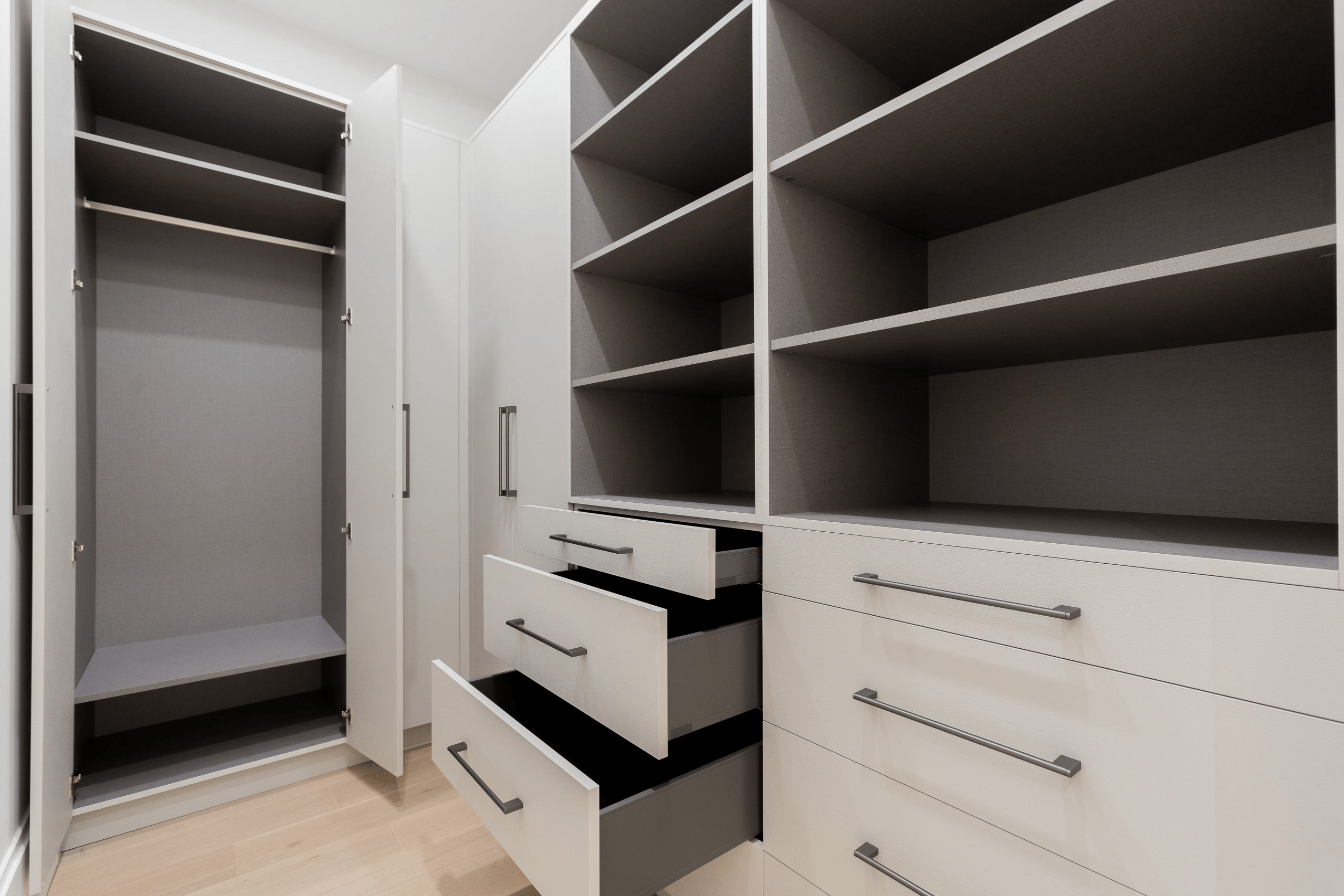 Modern custom kitchen with wood cabinets, white island, and built-in stainless steel appliances — Luminacraft Cabinets, Kitchener.