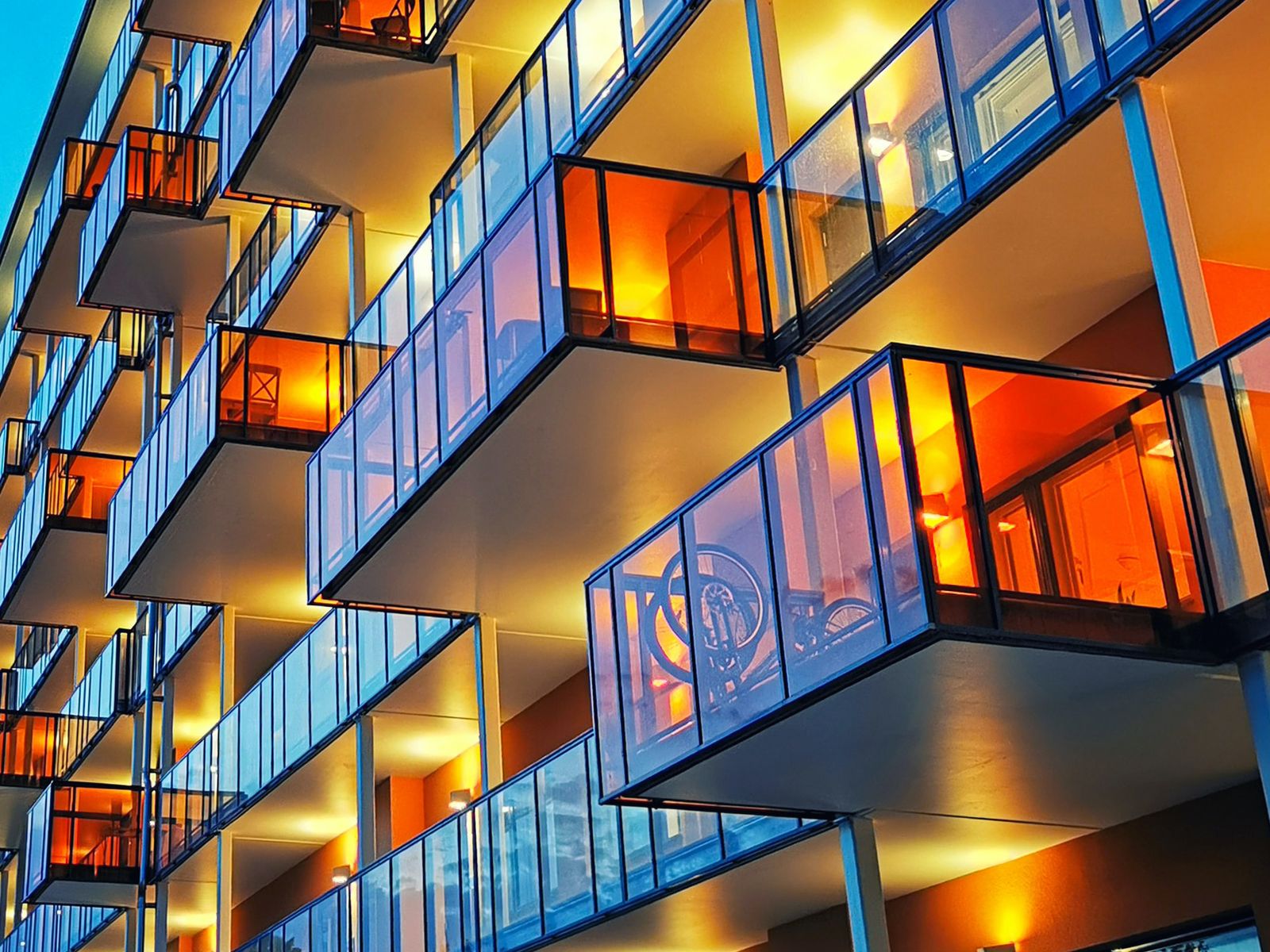 Lit balconies of a new apartment building at dusk