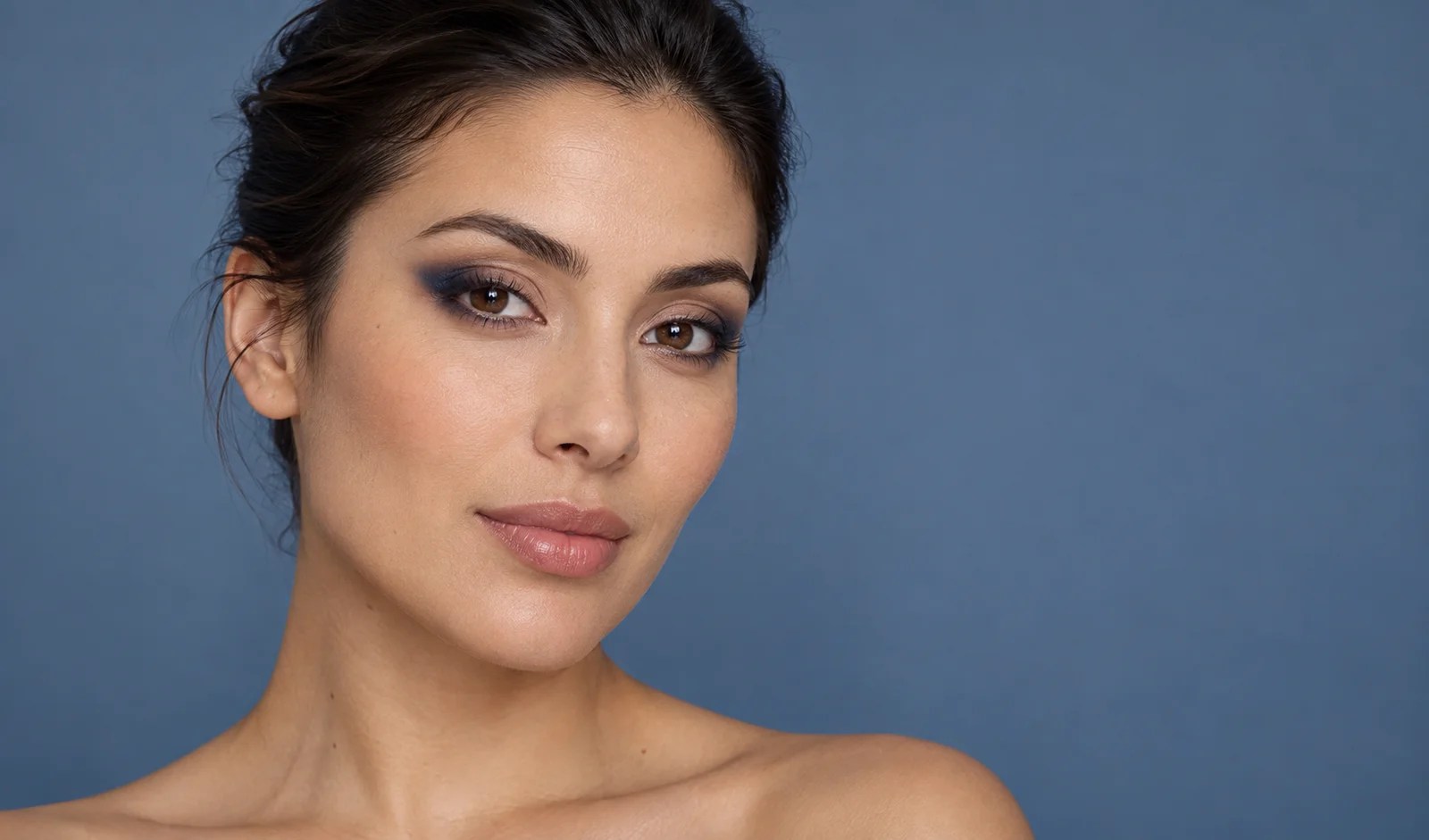 Navy blue eyeshadow softly blended at the outer corners of the eyes