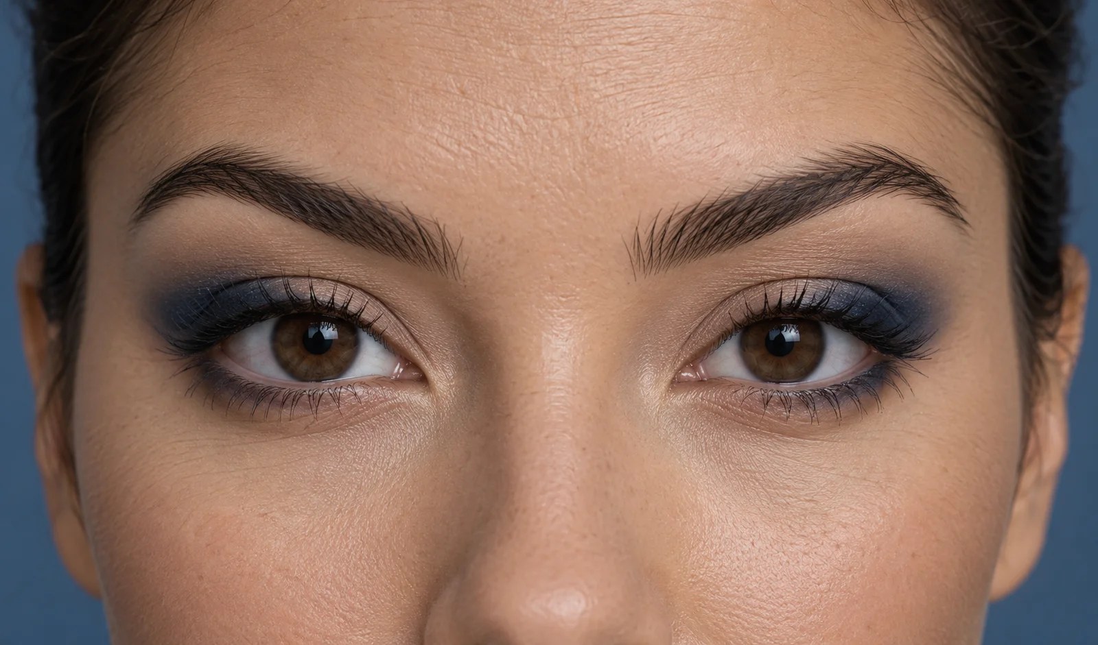 Navy eyeshadow diffused over the outer thirds of the eyes