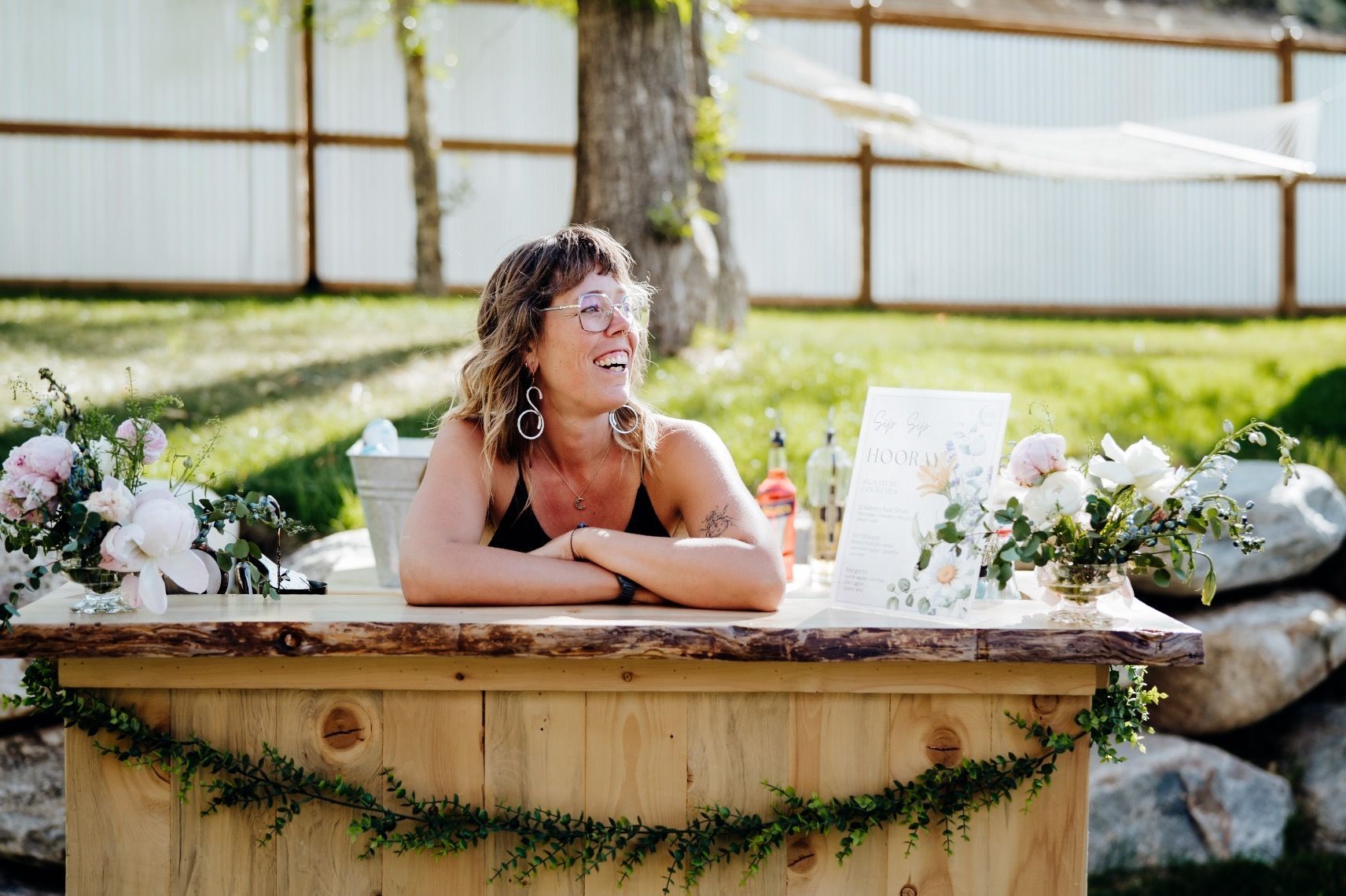 Mobile bartender smiling behind the bar