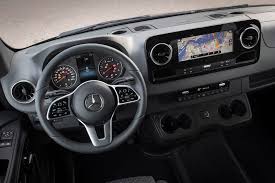 Interior view of a Mercedes-Benz van showing the dashboard, steering wheel, and navigation screen