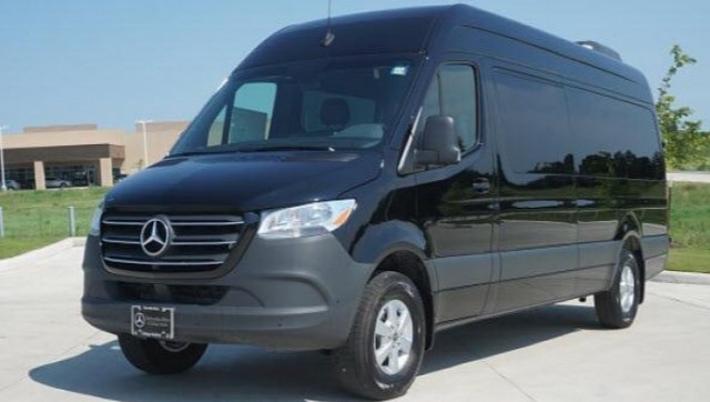 Black Mercedes-Benz Sprinter van parked in a lot, front three-quarter view