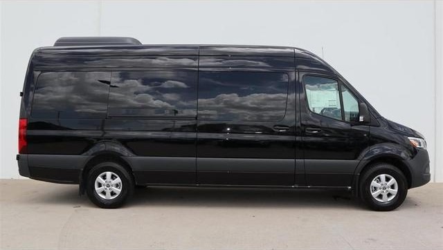 Black Mercedes-Benz Sprinter van, side profile view, parked on a light-colored surface