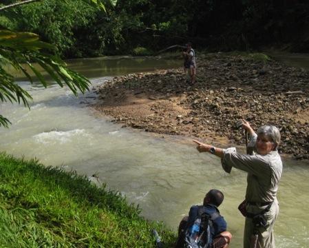 Lynette Silver with Dusun guides at the junction of the Taviu and Lolosing/Taguk rivers. Lynette is pointing (left) to the site of the large Lolosing Camp and ammunition dump.