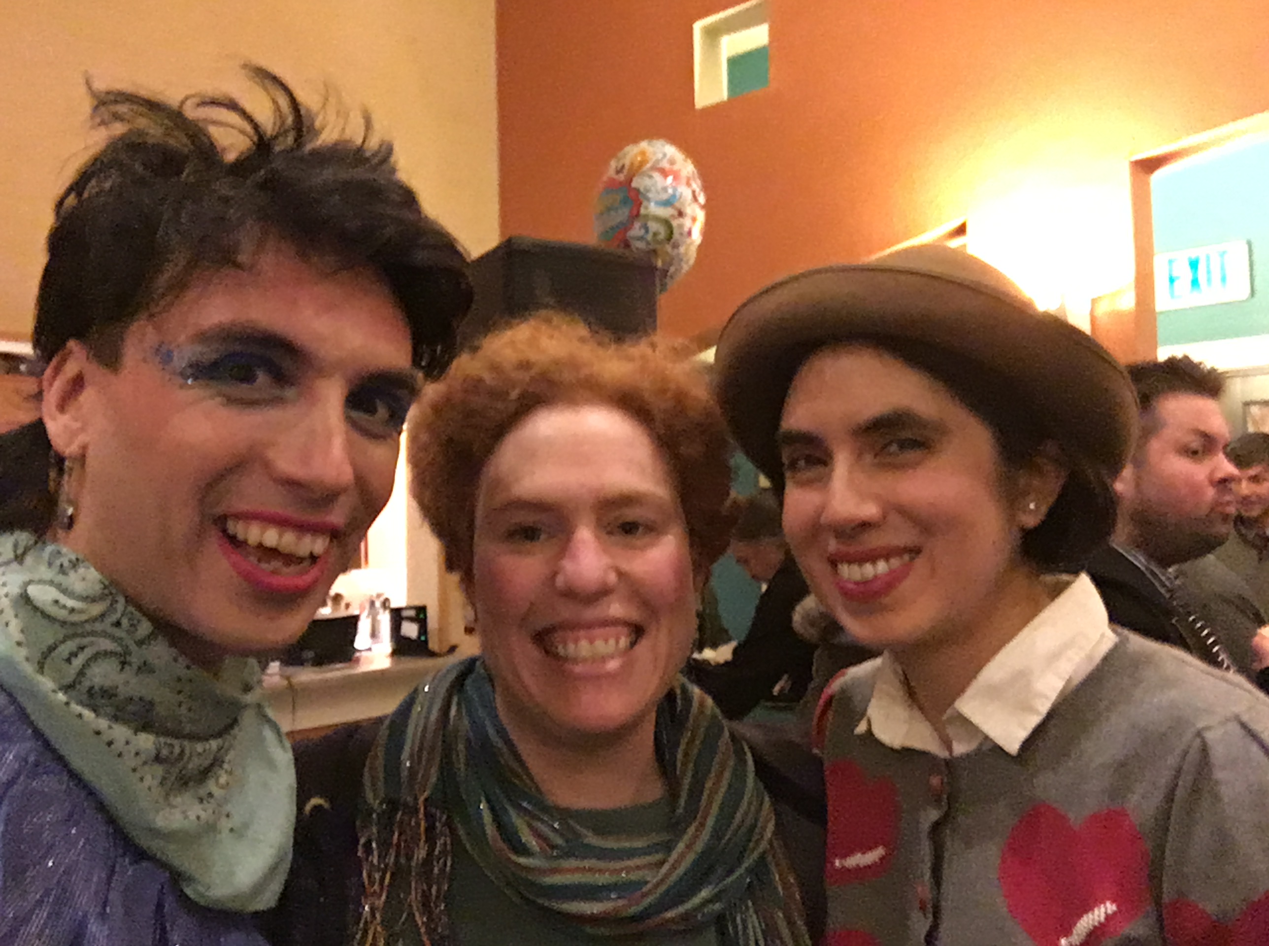 L: Llano has light brown skin and is wearing ascot. Ma'ayan wearing striped scarf. Star has light brown skin and is wearing bowler hat and grey sweater w/red hearts.