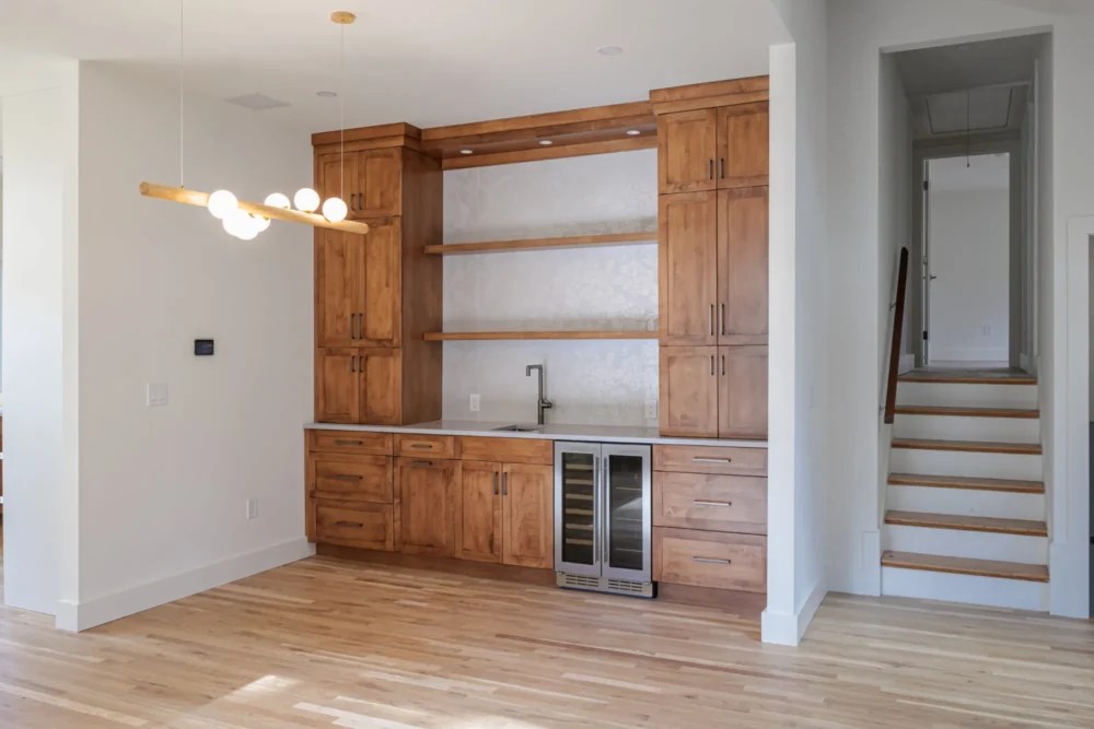 Custom wet bar with wine refrigerator and tile backsplash in Lexington MA