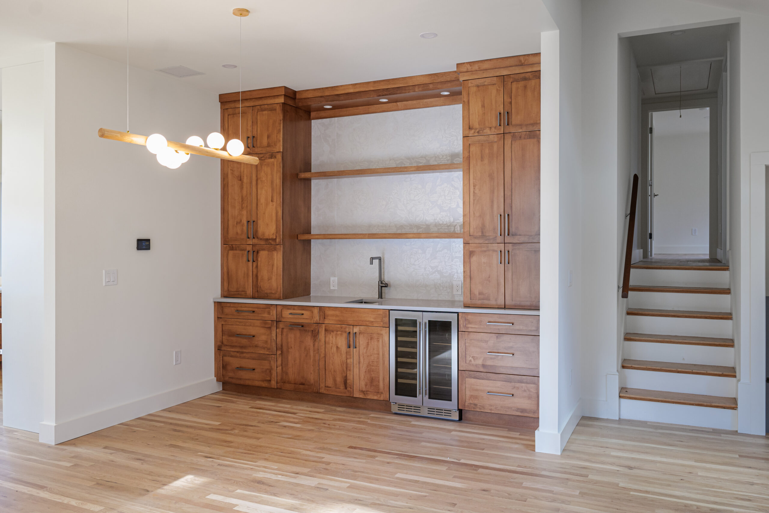 Custom wet bar with wine refrigerator and tile backsplash in Lexington MA