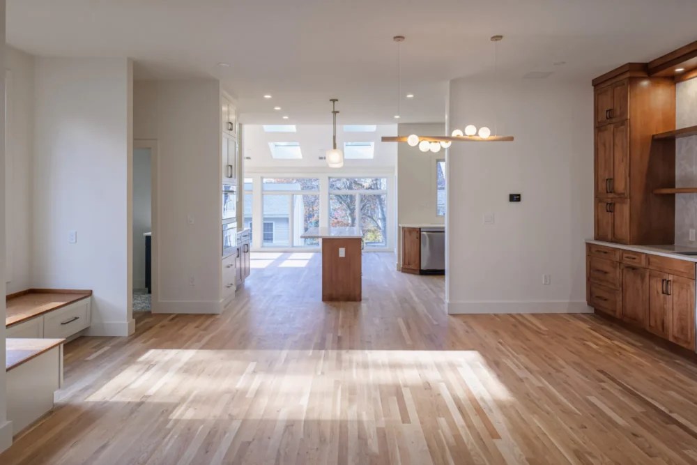 Open concept kitchen remodel with white oak floors and custom island in Lexington MA