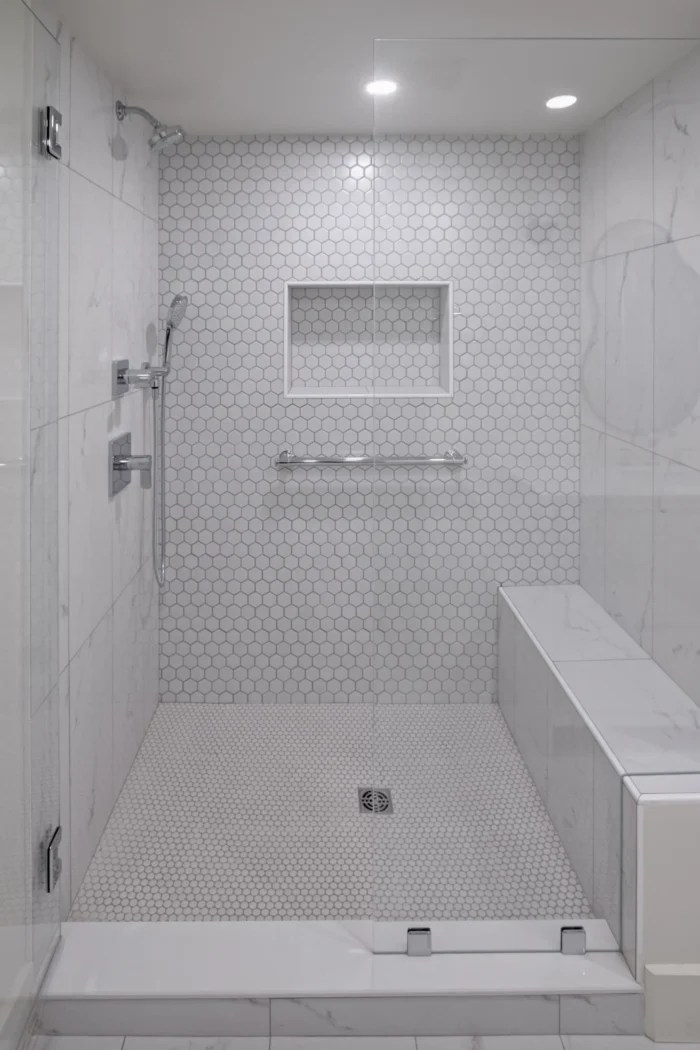 Walk in shower with marble bench and hex tile in a Lexington MA bathroom remodel